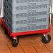 A grey plastic dolly base with red accents.