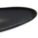 A close up of a black Reserve by Libbey Pebblebrook porcelain tray with an organic design.