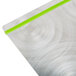 A Menu Solutions Alumitique aluminum menu board with green bands on a metal surface.