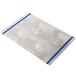 A white rectangular Alumitique menu board with a spiral design and navy blue bands.