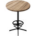 A round wooden table with a black base.