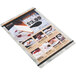 A Menu Solutions Alumitique menu board with black bands holding a menu on a white background.