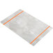 A white rectangular Alumitique menu board with orange swirls on a metal surface.
