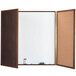 A wooden cabinet with a whiteboard and cork bulletin board inside.
