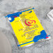 A Menu Solutions Alumitique menu board with royal blue bands on a yellow table.