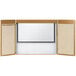 An oak laminate conference cabinet with a white board inside.