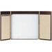 A brown and white rectangular cabinet with a white markerboard on the doors.