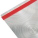 A Menu Solutions Alumitique aluminum menu board with red bands on a table with a metal surface.