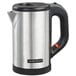 A Hamilton Beach stainless steel water kettle on a counter in a hotel room.