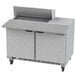A Beverage-Air stainless steel sandwich prep table with two open doors on a counter.
