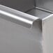 A close up of an Advance Tabco stainless steel commercial sink with metal corners.