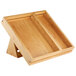 A wooden tray with a triangular base and two compartments on it.