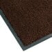 A dark brown carpet entrance mat with a gray border.