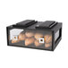 A black acrylic bakery building block drawer filled with bread on a counter.