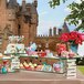 A rectangular glass shelf with cupcakes on it.