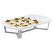 A white rectangular tray with food on it displayed on silver risers.