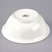 A white Tuxton china footed salad bowl.