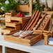 A table with different types of bread in Rosseto bamboo trays.