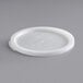 A white translucent plastic lid on a gray surface.
