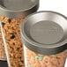 A white Rosseto triple cereal dispenser with cereal inside.