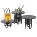 A group of black Rosseto tempered glass riser shelves on tables with drinks and fruit.