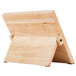 A Mercer Culinary Millennia® rubberwood magnetic board with white handles on a table.
