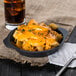 A plate of cheesy pasta and a Libbey mini cast iron pie pan with a glass of beer.