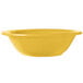 A yellow bowl sitting on a table.