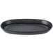 A black oval cast iron fajita skillet with a handle.