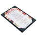 A black Menu Solutions wood menu board on a counter.