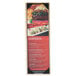 A Menu Solutions wood menu board with picture corners on a table with a plate of food.