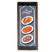 A Menu Solutions customizable wood menu board on a table with food displayed on it.