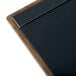A brown wood menu board with top and bottom metal strips.