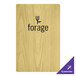 A Menu Solutions customizable wood menu board on a table with a logo.