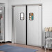 Regency double aluminum swinging traffic door with windows in a room.