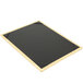 A wooden framed black board with gold picture corners.