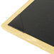A natural wood menu board with picture corners on a table.