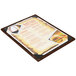 A Menu Solutions customizable wood menu board on a table with a picture of food.