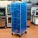 A blue Curtron mesh cover on a bun pan rack.