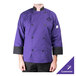 A person wearing a Mercer Culinary purple chef coat.