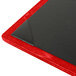 A customizable wood menu board with black and red corners on a table.