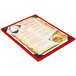 A Menu Solutions wood menu board with picture corners on a table with a red menu holder.