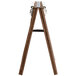 A Menu Solutions walnut wood menu board tent with metal clip.