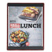 A Menu Solutions mahogany wood menu board with top and bottom strips on a table with a sandwich and a salad.