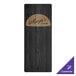 A black wood Menu Solutions menu board on a table with a wooden wine bottle and a logo.