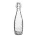 An Acopa clear glass water bottle with a clear swing top lid.