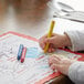 A child coloring a picture with Choice triangular kids' restaurant crayons.