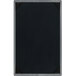 A Menu Solutions customizable wood menu board with silver picture corners on a table.