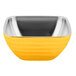 A yellow Vollrath square metal bowl with a silver rim and a stainless steel handle.