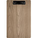 A weathered walnut wood clipboard with a black clip.